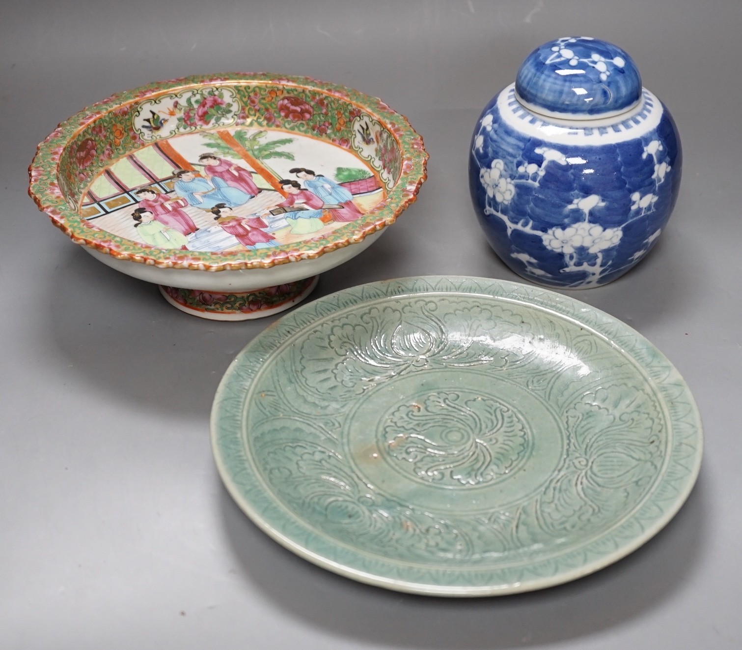 A Chinese famille rose pedestal dish, 23cm, a Thai celadon dish and a blue and white prunus jar and cover.